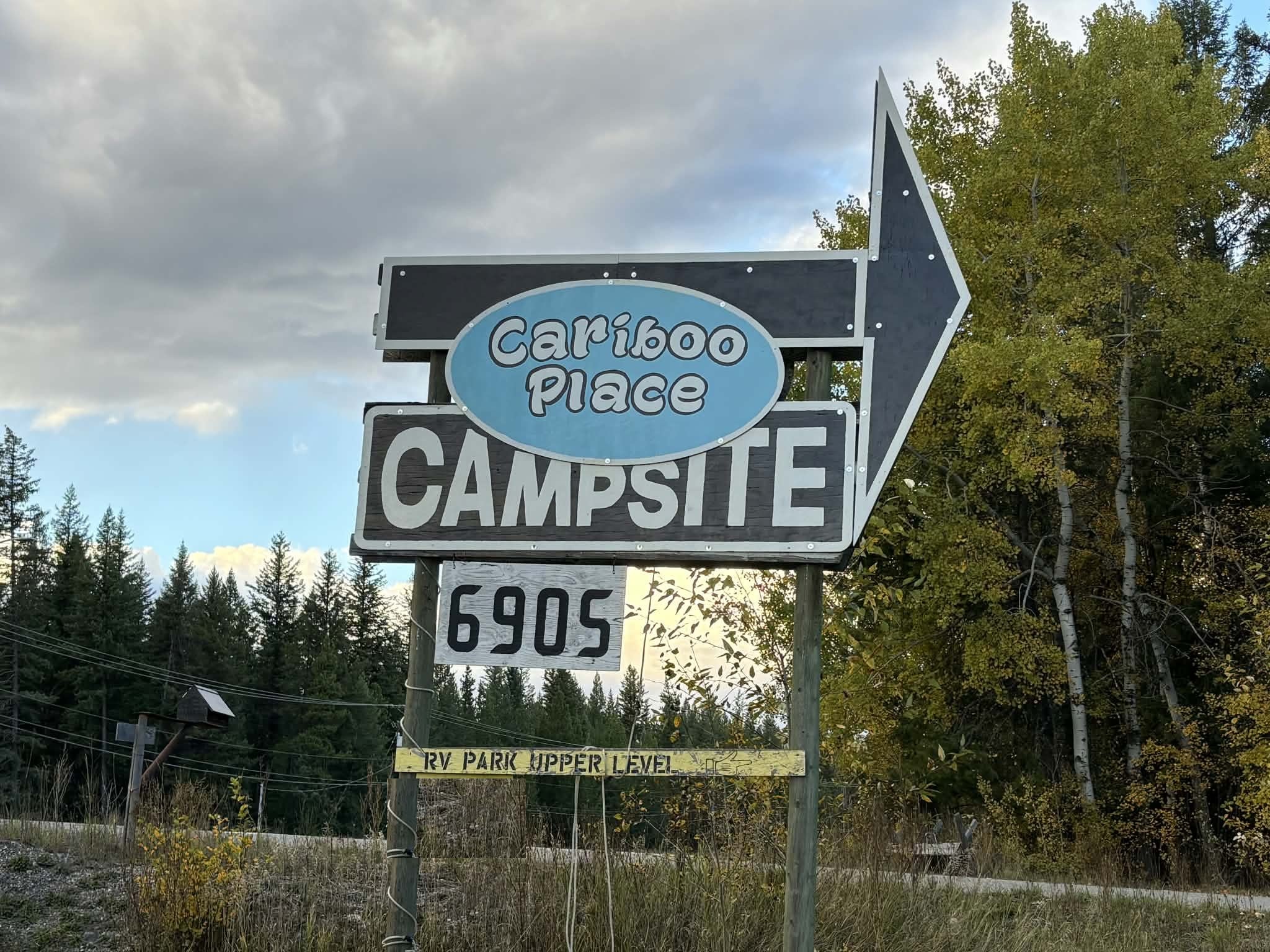 Real Cariboo Place Campsite roadside sign at 6905 Highway 97 S