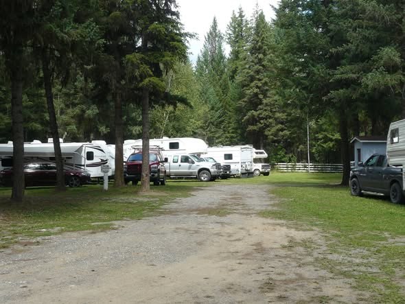 Gravel lane winding past treed RV sites at Cariboo Place Campsite